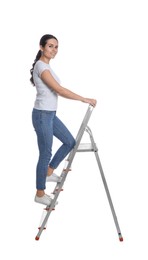 Young woman climbing up metal ladder on white background