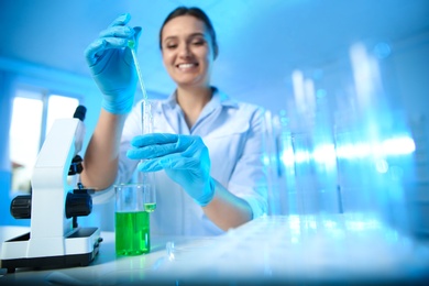 Female scientist working with sample in modern chemistry laboratory