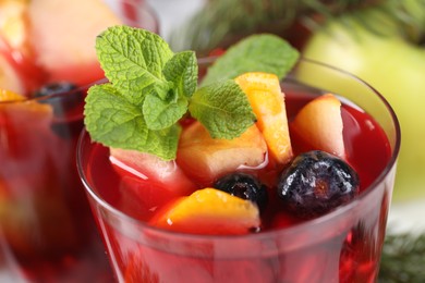 Photo of Aromatic Sangria drink in glass on table, closeup