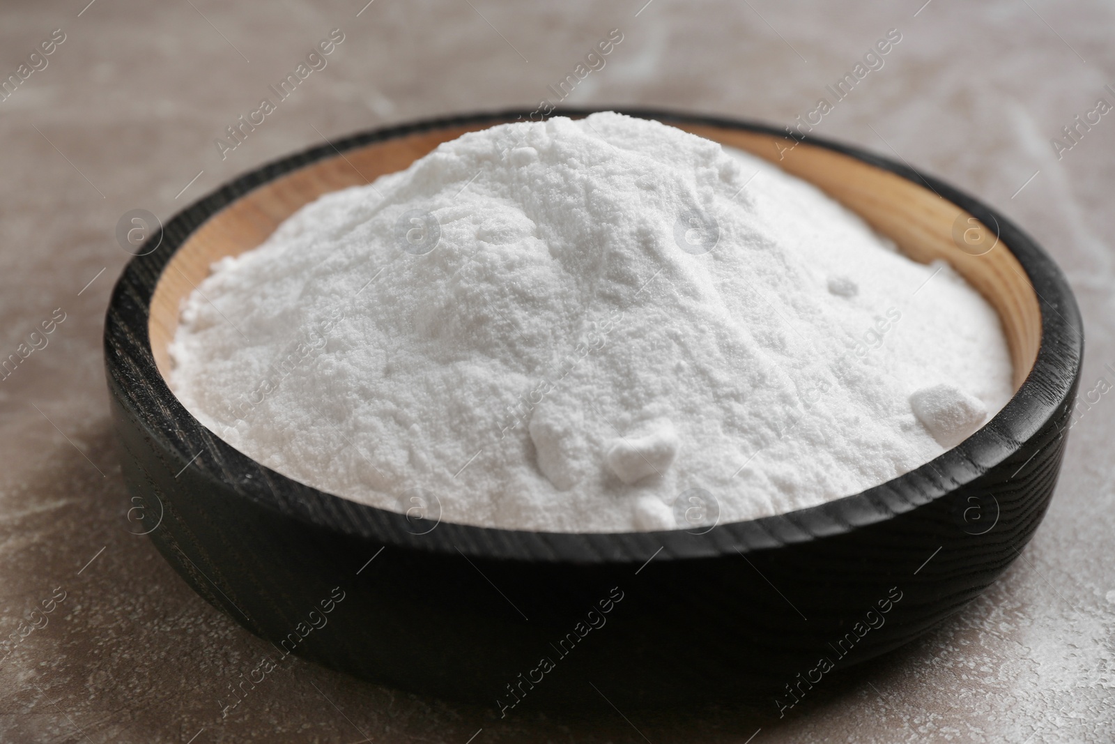 Photo of Plate with baking soda on grey background