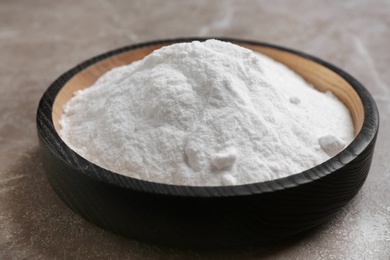 Photo of Plate with baking soda on grey background