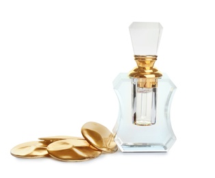 Photo of Glass bottle of perfume and luxury jewellery isolated on white