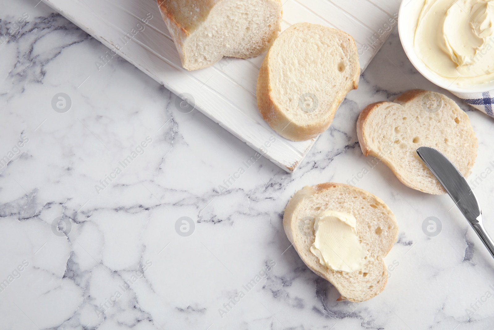 Photo of Flat lay composition with bread for breakfast on marble table. Space for text