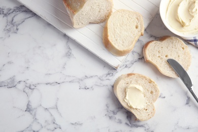 Flat lay composition with bread for breakfast on marble table. Space for text