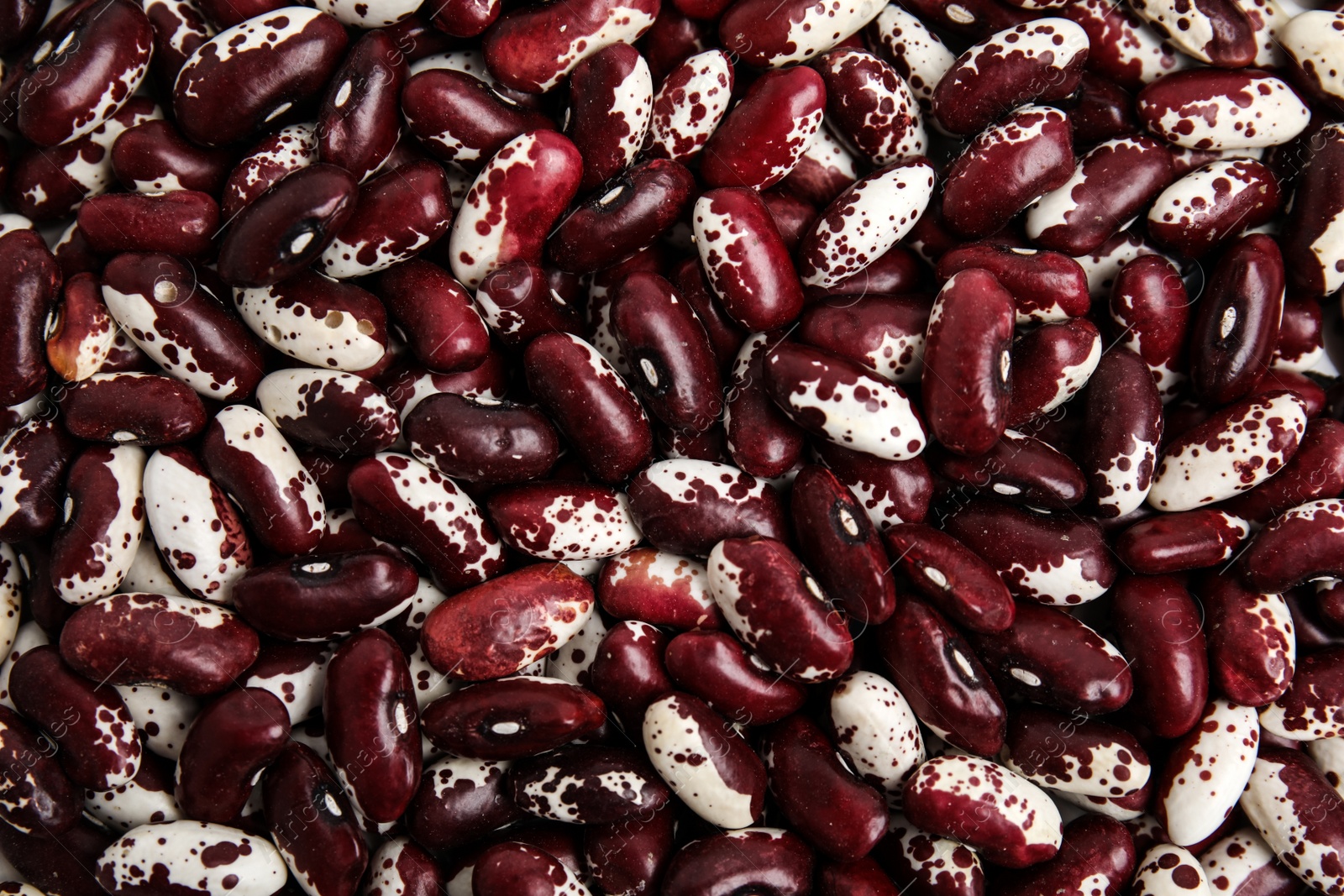 Photo of Heap of raw beans as background, top view. Veggie seeds