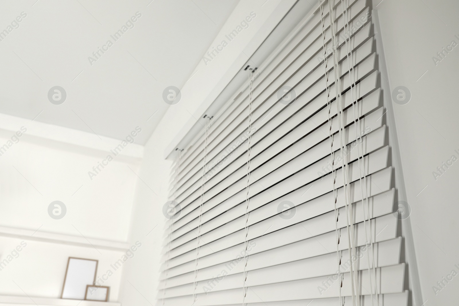 Photo of Window with closed blinds in room, closeup