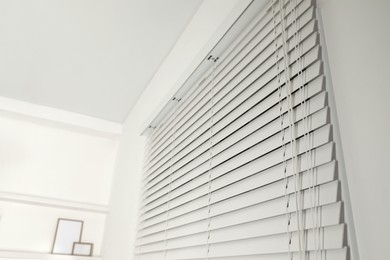 Window with closed blinds in room, closeup