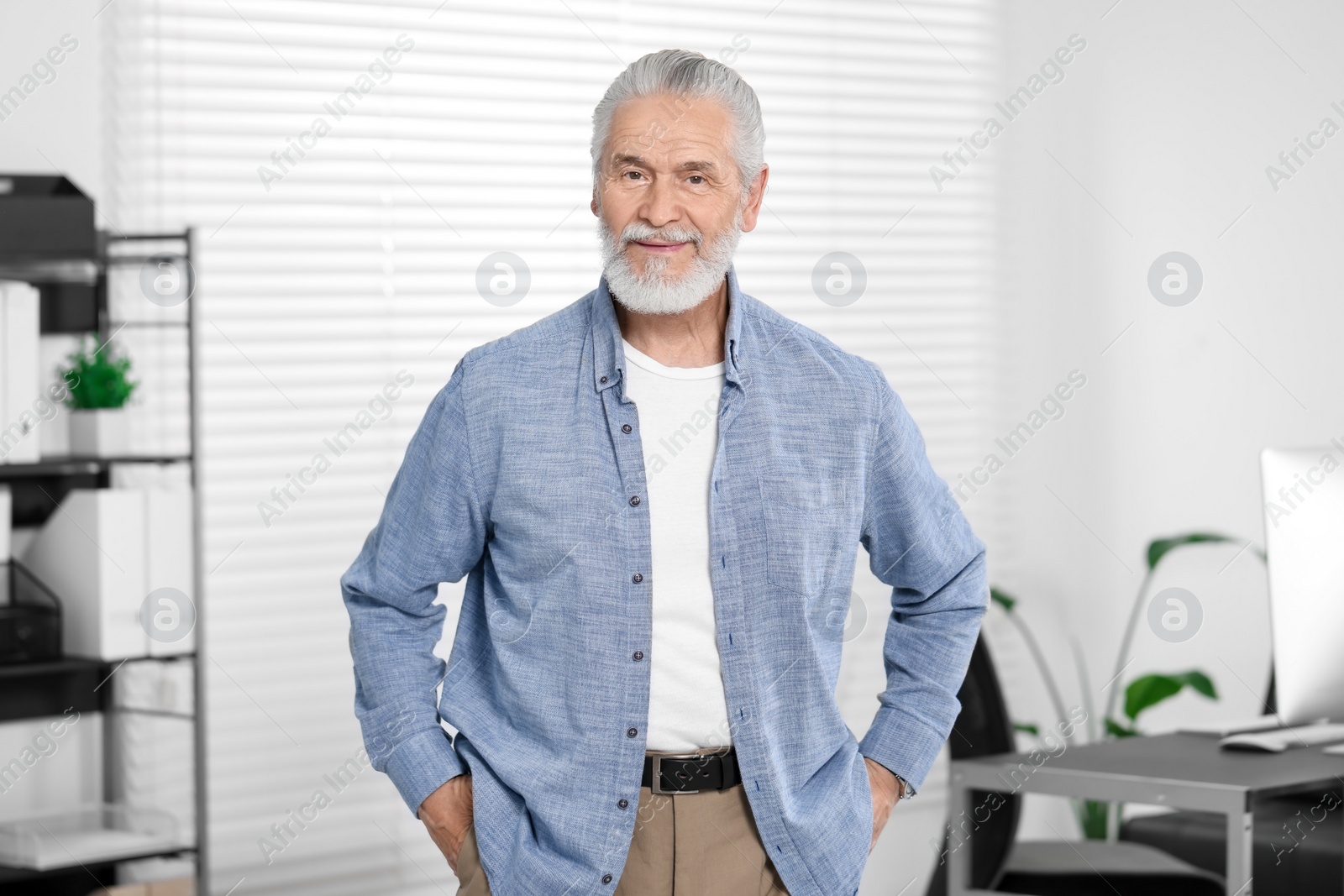 Photo of Portrait of handsome senior man in office