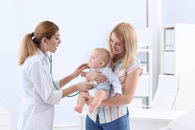 Photo of Woman with her baby visiting children's doctor in hospital