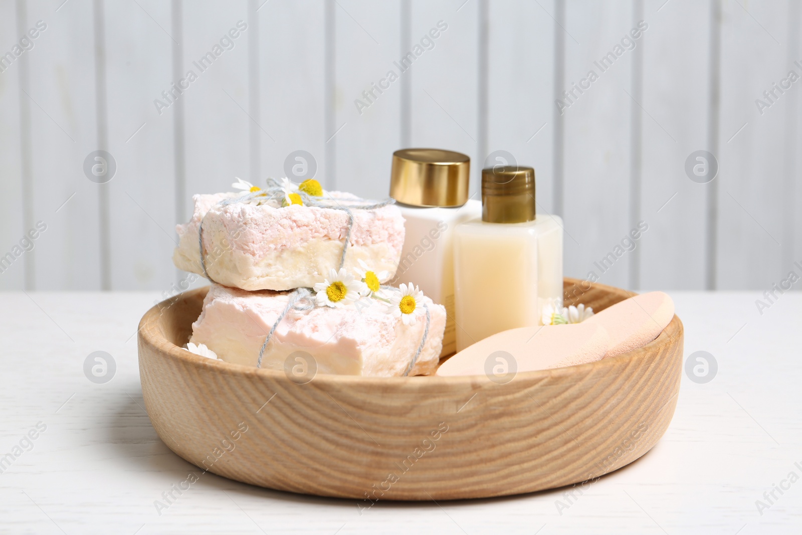 Photo of Composition with chamomile flowers and cosmetic products on white table