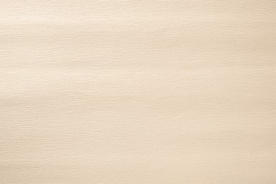 Photo of Texture of beige paper sheet as background, closeup