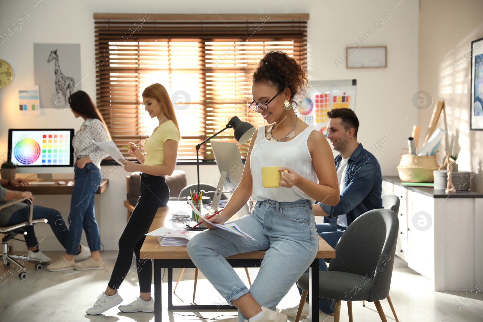 Photo of Happy female designer working in modern office