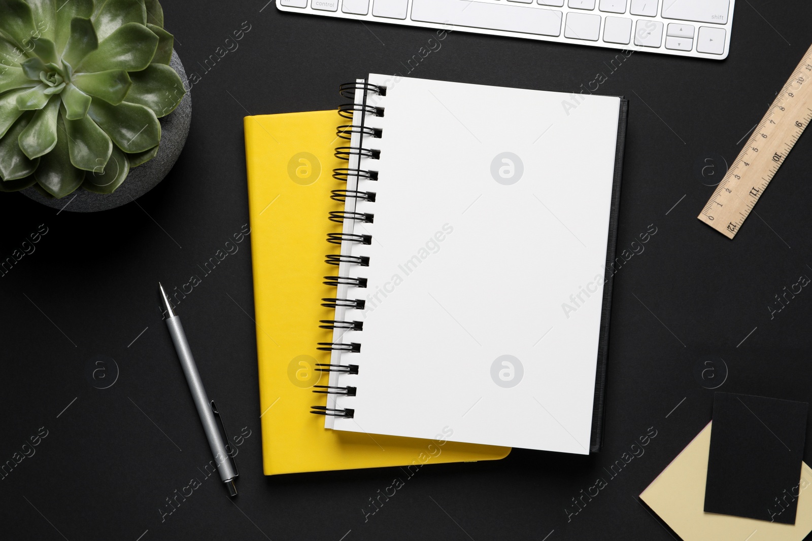 Photo of Flat lay composition with stylish notebooks on black background