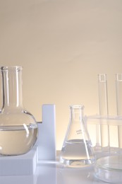 Photo of Laboratory analysis. Different glassware on table against beige background