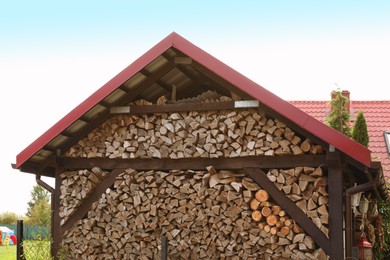 Photo of Many different dry firewood in storage outdoors