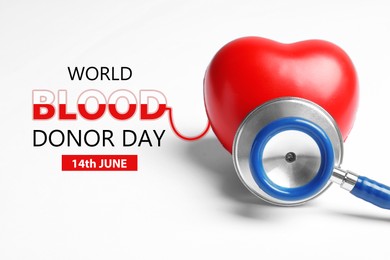 Image of World Blood Donor Day. Stethoscope and heart model on white background, closeup