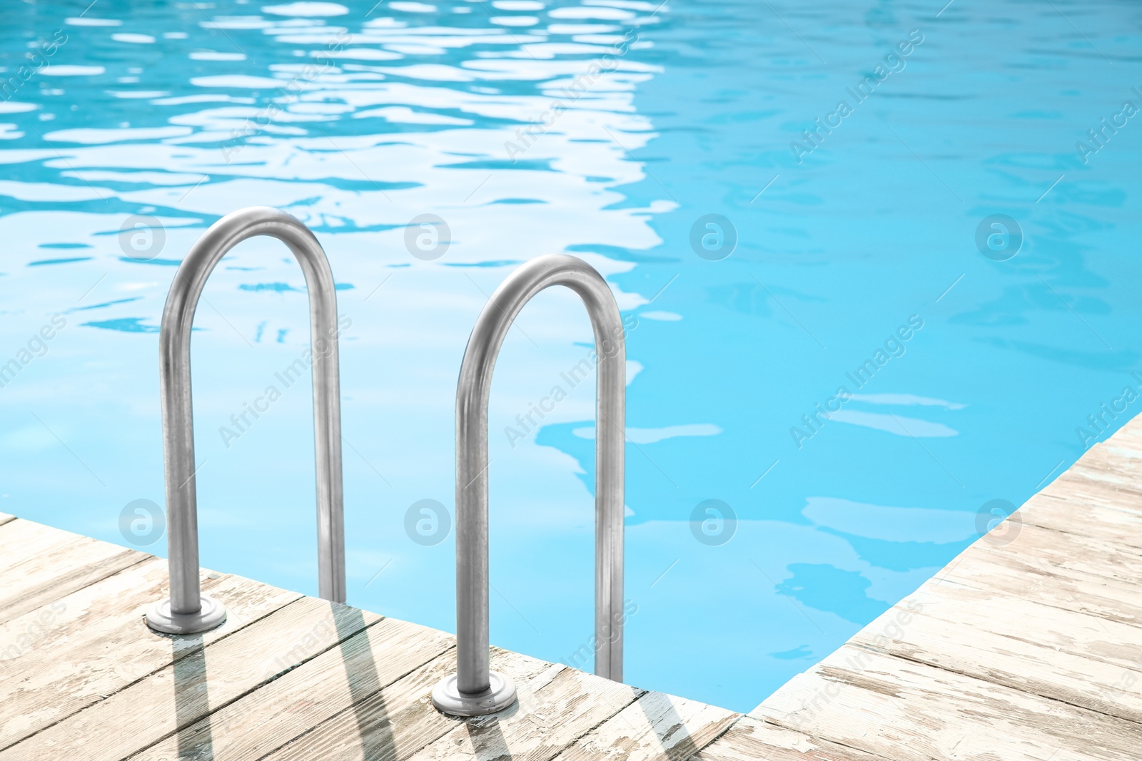 Photo of Ladder with grab bars in outdoor swimming pool