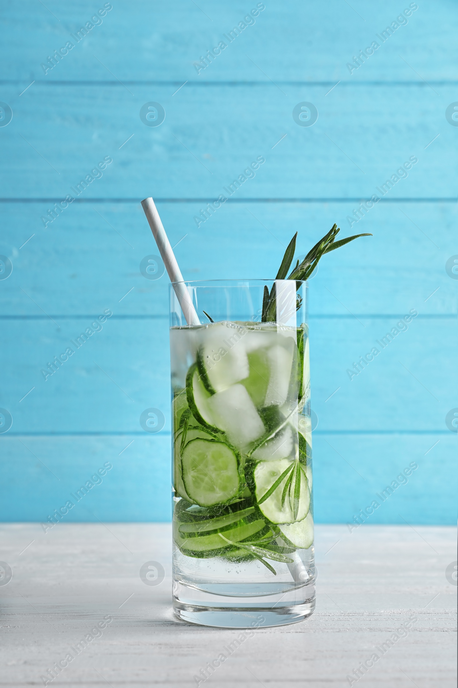 Photo of Natural lemonade with cucumber in glass on wooden table