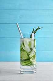 Photo of Natural lemonade with cucumber in glass on wooden table