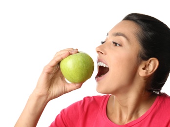 Young woman with healthy teeth and apple on white background