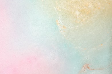 Colorful foam after dissolving bath bomb in water, closeup