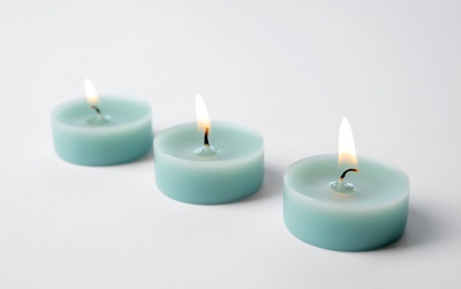 Photo of Light blue wax decorative candles isolated on white