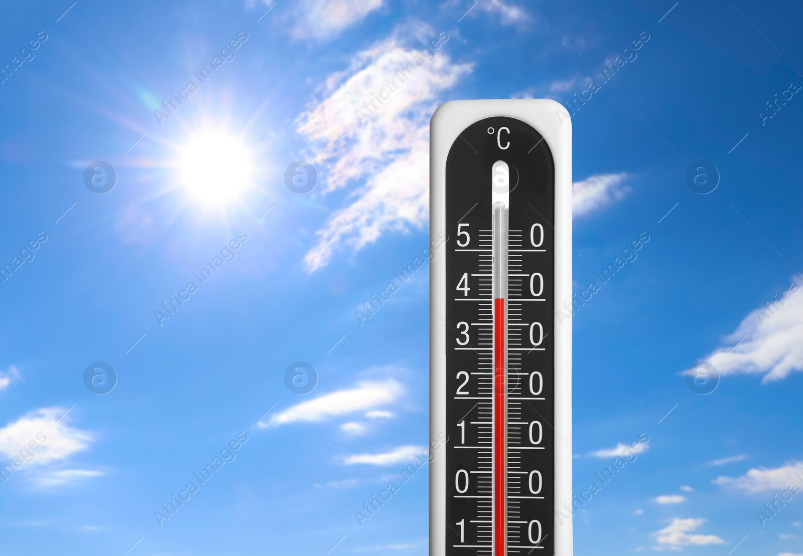 Image of Weather thermometer with high temperature outdoors on hot sunny day. Heat stroke warning