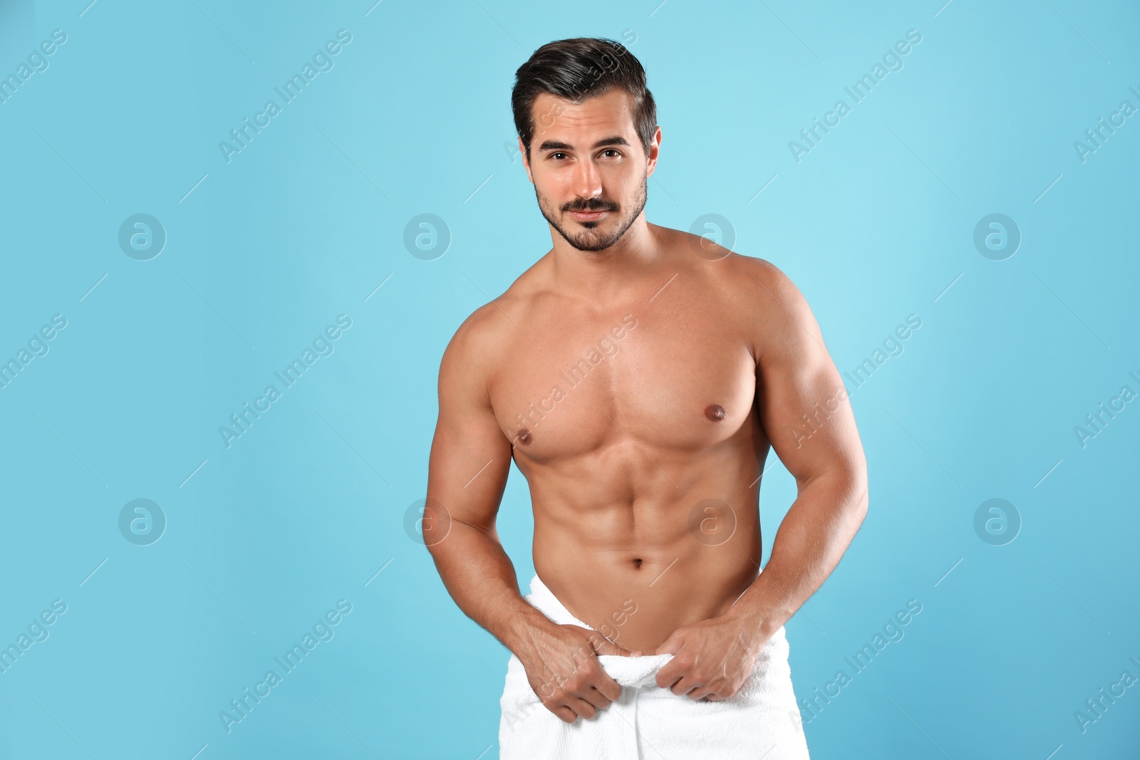 Photo of Young man with slim body on light blue background