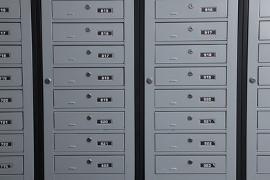 Photo of Closed metal mailboxes with keyholes and sequence numbers indoors