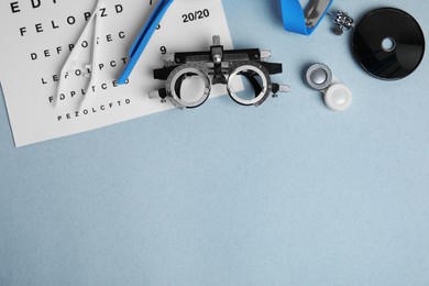 Photo of Different ophthalmologist tools on grey background, flat lay. Space for text