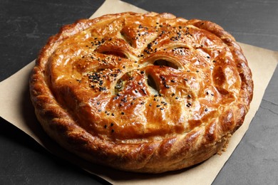 Photo of Tasty homemade pie with filling on grey table