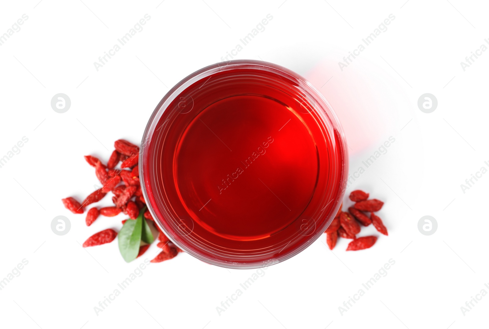 Photo of Healthy goji juice in glass with berries on white background, top view