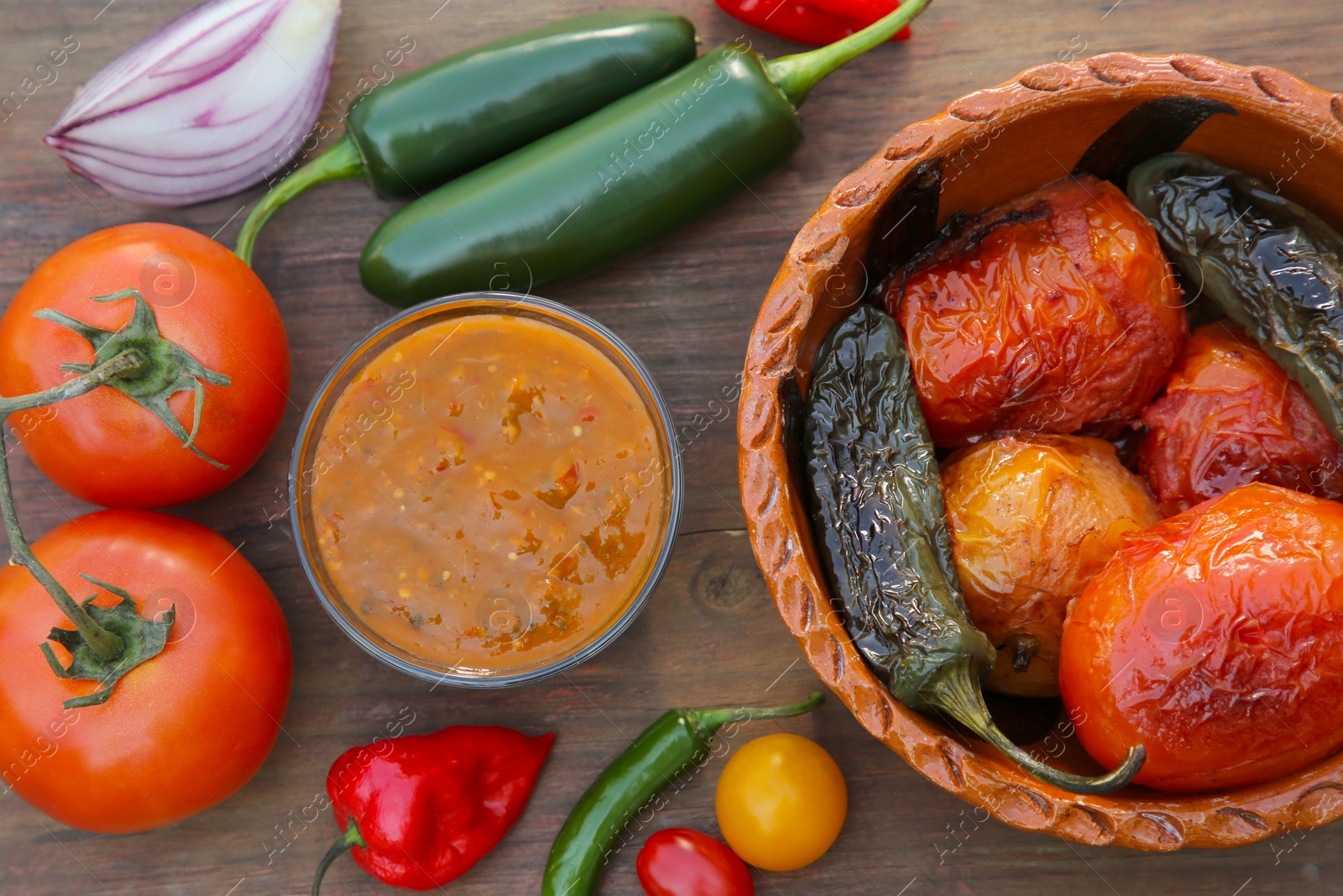 Photo of Tasty salsa sauce and ingredients on wooden table, flat lay