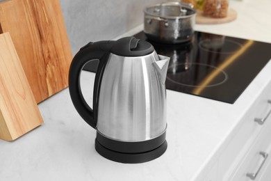 Modern electric kettle on counter in kitchen