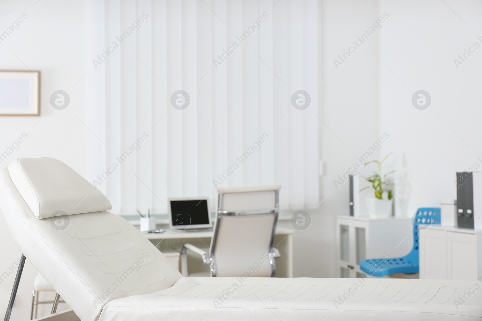 Photo of Modern medical examination couch in doctor's office