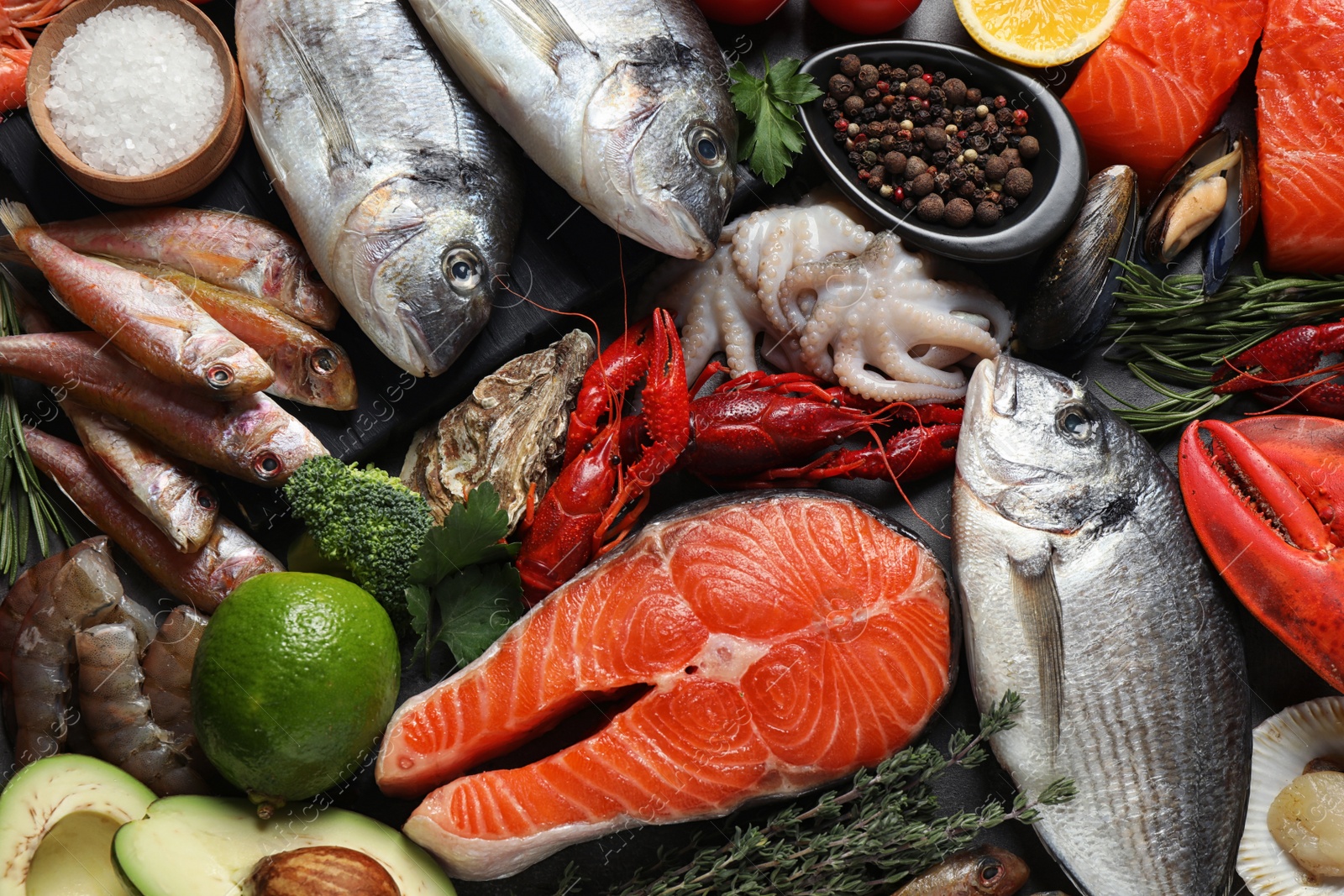 Photo of Fresh fish and different seafood on table, flat lay