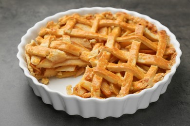 Photo of Tasty homemade quince pie on grey table, closeup