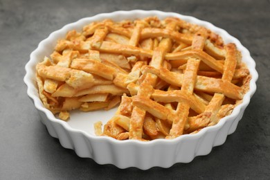 Tasty homemade quince pie on grey table, closeup