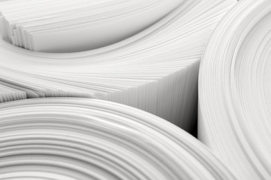 Photo of Rolled white paper sheets as background, closeup