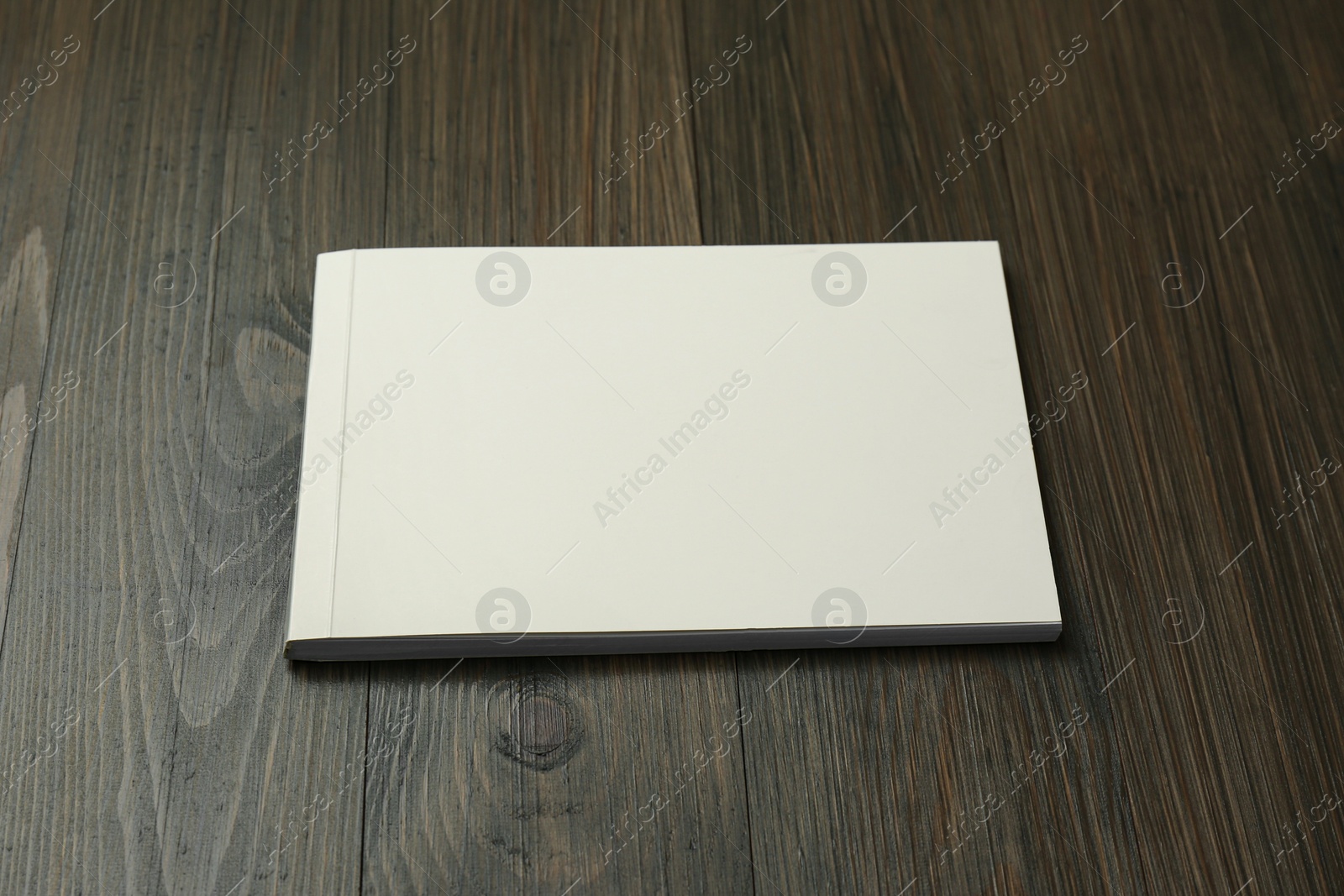 Photo of Blank paper brochure on wooden table. Mockup for design