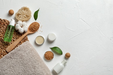 Flat lay composition with spa cosmetics and towel on white background