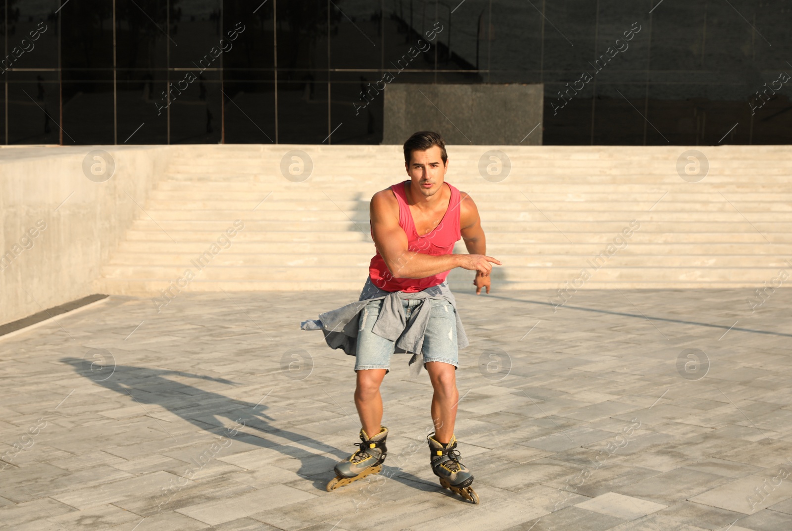 Photo of Handsome young man roller skating on city street