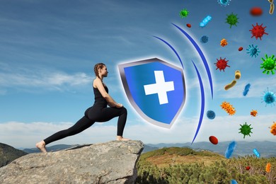 Image of Woman practicing yoga on rock in mountains. Strong immunity - shield against viruses
