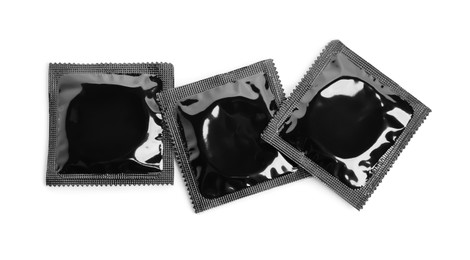 Condom packages on white background, top view. Safe sex