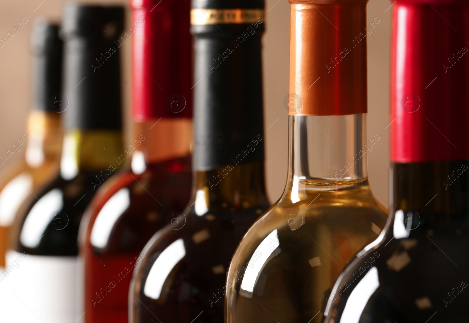 Photo of Bottles of different wines, closeup. Expensive collection