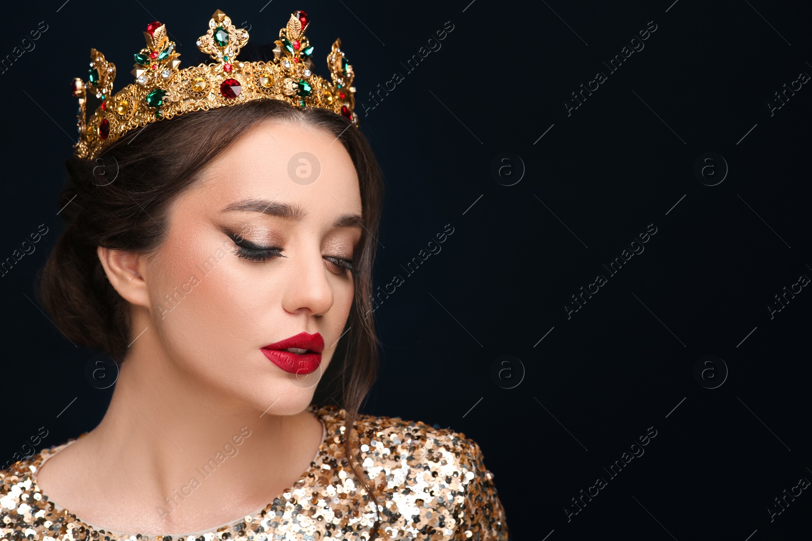 Photo of Beautiful young woman wearing luxurious crown on black background, space for text