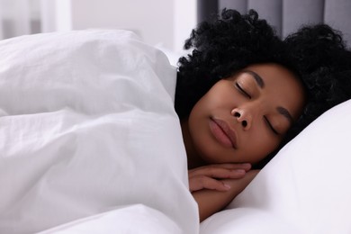 Photo of Beautiful young woman sleeping in soft bed