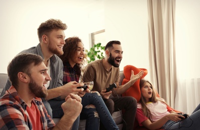 Emotional friends playing video games at home