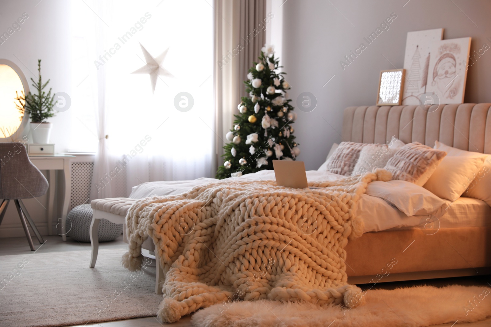 Photo of Beautiful decorated Christmas tree in bedroom interior