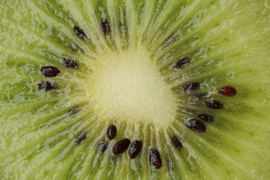 Tasty kiwi with seeds as background, macro